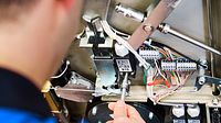 Service technician maintains a Polaris II platform lift