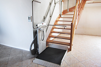 Platform lift inside curved – wooden staircase